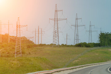 High voltage towers with sky background. Power line support with wires for electricity transmission. High voltage grid tower with wire cable at distribution station. Energy industry, energy saving