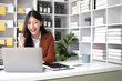 © Kainnika - Successful Asian businesswoman happy looking at laptop and excited.
