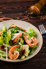 Wall Mural - Salad of grilled shrimp, avocado, sun-dried tomatoes, parmesan cheese, lettuce and arugula.