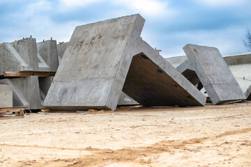 Wall Mural - Large reinforced concrete structures at the construction site. Preparation for the installation of reinforced concrete products. Construction work on the construction of foundations.