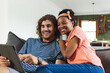© WavebreakMediaMicro - Diverse couple young African American woman and Caucasian man share a tablet, smiling together