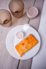 Wall Mural - Cottage cheese casserole with sweet sauce on table.