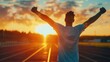 © buraratn - Successful man raising arms after cross track running on summer sunset. Fitness male athlete with arms up celebrating success and goals after sport exercising and working out.