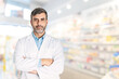 Medium shot of male pharmacist on blurred pharmacy background 