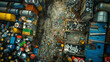 Bird's-eye view of a sprawling scrapyard with assorted metal drums, containers, and various recyclable debris