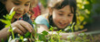 Two young girls engaging in planting, immersed in the joy of gardening together.