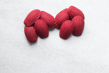 Sticker - Top view of Red velvet madeleines on a marble tray, red madeleines cake or cookies for bakery