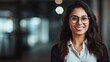 © ORG - Beautiful Indian businesswoman wearing a shirt and standing outside a conference room Portrait of a happy businesswoman