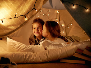 Sticker - Children, happy and playing in tent at night with love, kiss and bonding for holiday adventure or vacation. Young boy, girl or kids by fairy lights, pillows and blanket at home with thinking or ideas