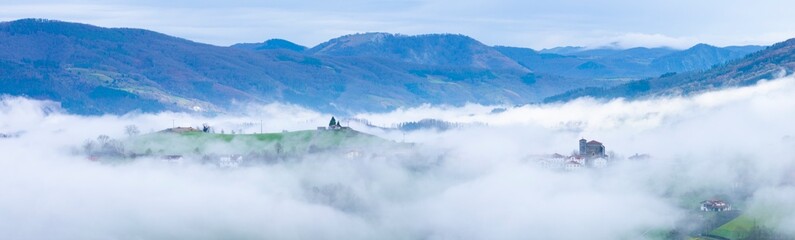 Wall Mural - Aerial drone view of the winter landscape around the town of Gainza and Amezqueta and the Txindoki Mountain. Aralar Mountain Range. Goierri region. Gipuzkoa. Basque Country. Spain. Europe