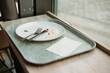 © mdyn - lunch tray with Empty dirty dish. White plate with fork and knife on table after dinner