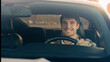 © Yuliia - Caucasian handsome smiling man businessman sit inside modern electric car driving automobile in city road trip travel happy joyful male owner driver guy drive vehicle transport rent buy luxurious auto