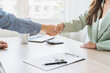 Sell agent, success deal asian young woman handshake or shaking hands with landlord realtor, client male after buyer man signed rental, lease contract. Banker agreement mortgage loan, property lease.