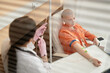 © Seventyfour - High angle portrait of bald young woman receiving chemotherapy treatment in procedure room at clinic behind glass copy space