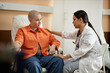 © Seventyfour - Side view portrait of young nurse comforting cancer patient receiving chemotherapy treatment in hospital