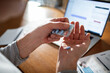 © Marko Geber - Close-up of a mans hands with medication and a laptop on a desk