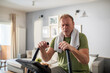 © Marko Geber - Tired middle aged man working out at home on fitness bike