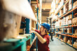 © Davor - Warehouse worker organizing boxes on shelves