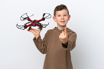 Wall Mural - Little Caucasian boy holding a drone isolated on white background doing coming gesture