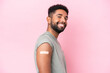 © luismolinero - Young Brazilian man wearing a band aid isolated on pink background with happy expression