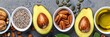 Assorted healthy fats like avocado, nuts, seeds, olive oil, with space for text or design placement.