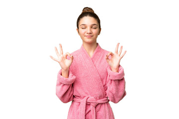 Canvas Print - Teenager girl in a bathrobe over isolated chroma key background in zen pose