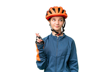 Poster - Teenager cyclist girl over isolated chroma key background with fingers crossing and wishing the best