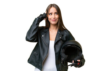 Wall Mural - Young pretty caucasian woman with a motorcycle helmet over isolated background having doubts and thinking