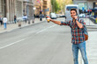 © Jelena - Man hailing taxi on city street. City life.