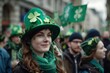 A group of people wearing green hats and holding shamrock banners, marching in a parade. St. Patrick's day