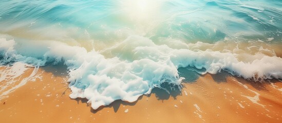 Poster - The aerial view captures the rhythmic movement of ocean waves crashing onto the sandy beach under the sun. The contrast between the blue water and golden sand creates a beautiful scene of nature.