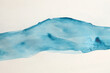 Ink watercolor hand drawn pour flow stain blot. Wave landscape on wet paper texture background.