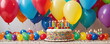 A vibrantly decorated birthday cake with lit candles is surrounded by a festive array of multicolored balloons and party decorations