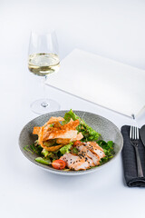 Sticker - Houston's salad with grilled chicken, tomatoes, lettuce, spinach, microgreens and peanuts with a glass of wine.