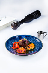 Canvas Print - Fried tenderloin steak with roasted peppers and green peas.