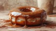 A sumptuous caramel-glazed donut resting on a wooden surface with caramel sauce dripping lusciously, an ideal image for dessert marketing and confectionery websites