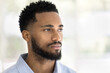 © fizkes - Serious handsome young African man indoor casual portrait. Thoughtful dreamy barber model, Black guy with stylish beard posing indoors, looking away in deep thoughts. Close up shot