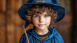 little cute boy in a suit and wizard's hat with a magic wand, child, kid, toddler, masquerade, play game, party, holiday, outfit, portrait, background, face, childhood, mantle, cloak, schoolboy
