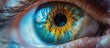 This close-up shot showcases the intricate details of a persons eye, with striking blue and yellow colors. The eye is the focal point, revealing its unique beauty and depth.