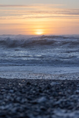 Wall Mural - The ocean is calm and the sun is setting, creating a beautiful