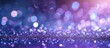 A defocused silver white and blue vintage lights create a mesmerizing effect on a glittery purple background, resulting in a blurry yet enchanting visual.