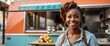 © Arceli - Small business owner young black african woman at front of food truck smiling looking at camera from Generative AI