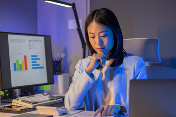 Wall Mural - An employee is sitting in a personal office doing work assigned by a boss, An office work scene with an entrepreneur sitting and working, concentrating on making a report in time.