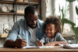 © Kien - Father helping cute girl daughter to do school homework at home