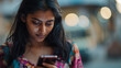 Indian Woman Looking at Cell Phone with Serious Focused Expression