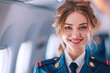 © Aris - caucasian woman wearing airline cabin crew uniform in commercial airplane