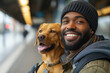A bearded man hugging a dog during a trip, the owner with his pet at the train station
