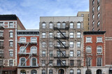 Fototapeta Big Ben - New York City old fashioned apartment buildings with external fire ladders