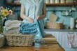 A woman standing next to a basket of towels. Suitable for household and cleaning concepts