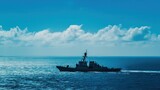 Fototapeta Uliczki - Military naval ship sailing on vast blue ocean under clear sky, demonstrating maritime security and defense capabilities. Maritime defense and strategy.